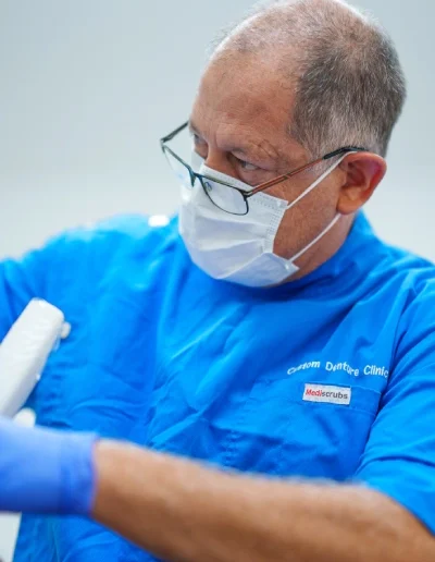 Dr André holding dental equipment