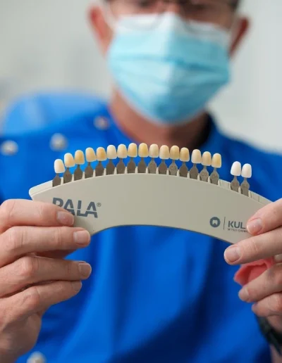 Dr Pierre holding whitening color swatches