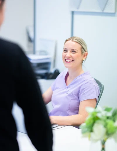 Dr Mills speaking with a patient during a consultation